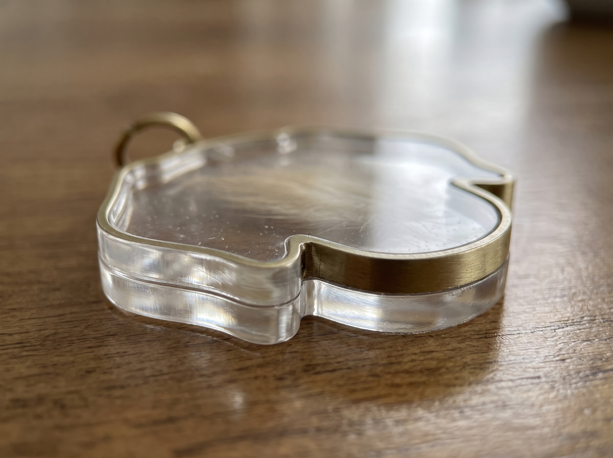 Polished acrylic edge and brass twist closure
